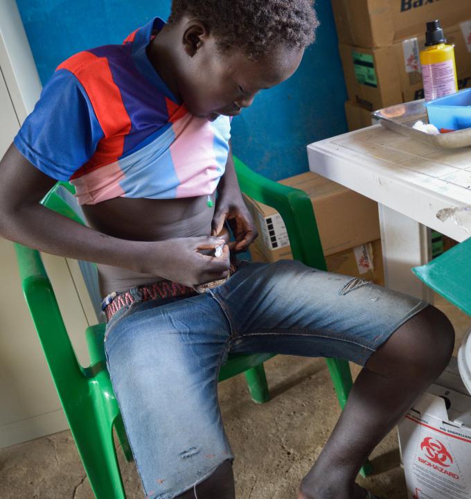 14-year-old Deng Gwin administering his own insulin injection as per instructions in MSF’s diabetes clinic in Agok hospital. His dreams of becoming a famous footballer have been set back by his illness, but he is feeling better with treatment