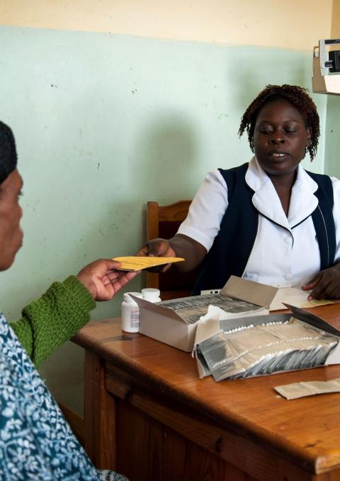 A health worker at Bvumbe Health Centre in Malawi’s Thyolo District dispenses antiretroviral medicines, Malawi 2013.