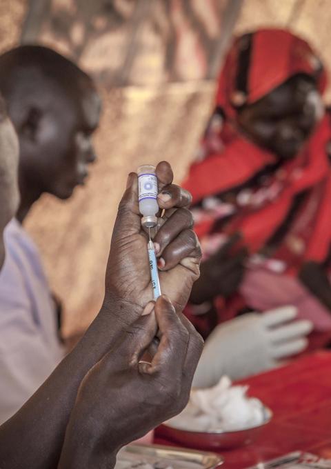 Health worker prepares PCV for a child during an MSF vaccination campaign in Yida refugee camp, South Sudan, July 2013.