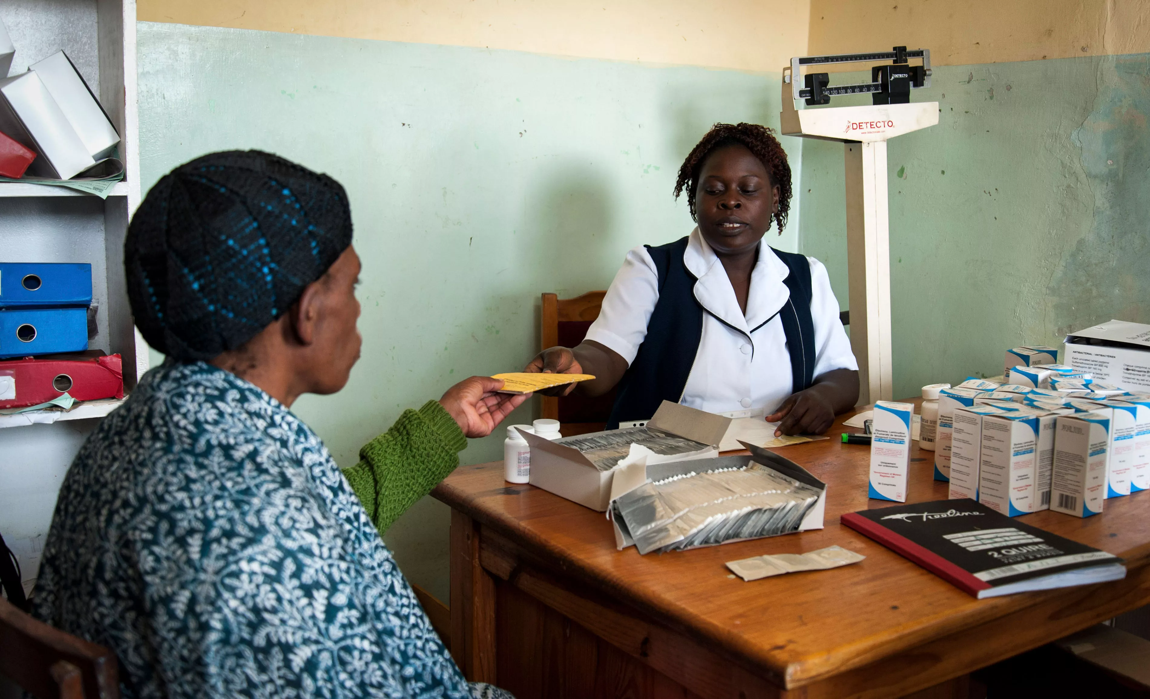 A health worker at Bvumbe Health Centre in Malawi’s Thyolo District dispenses antiretroviral medicines, Malawi 2013.