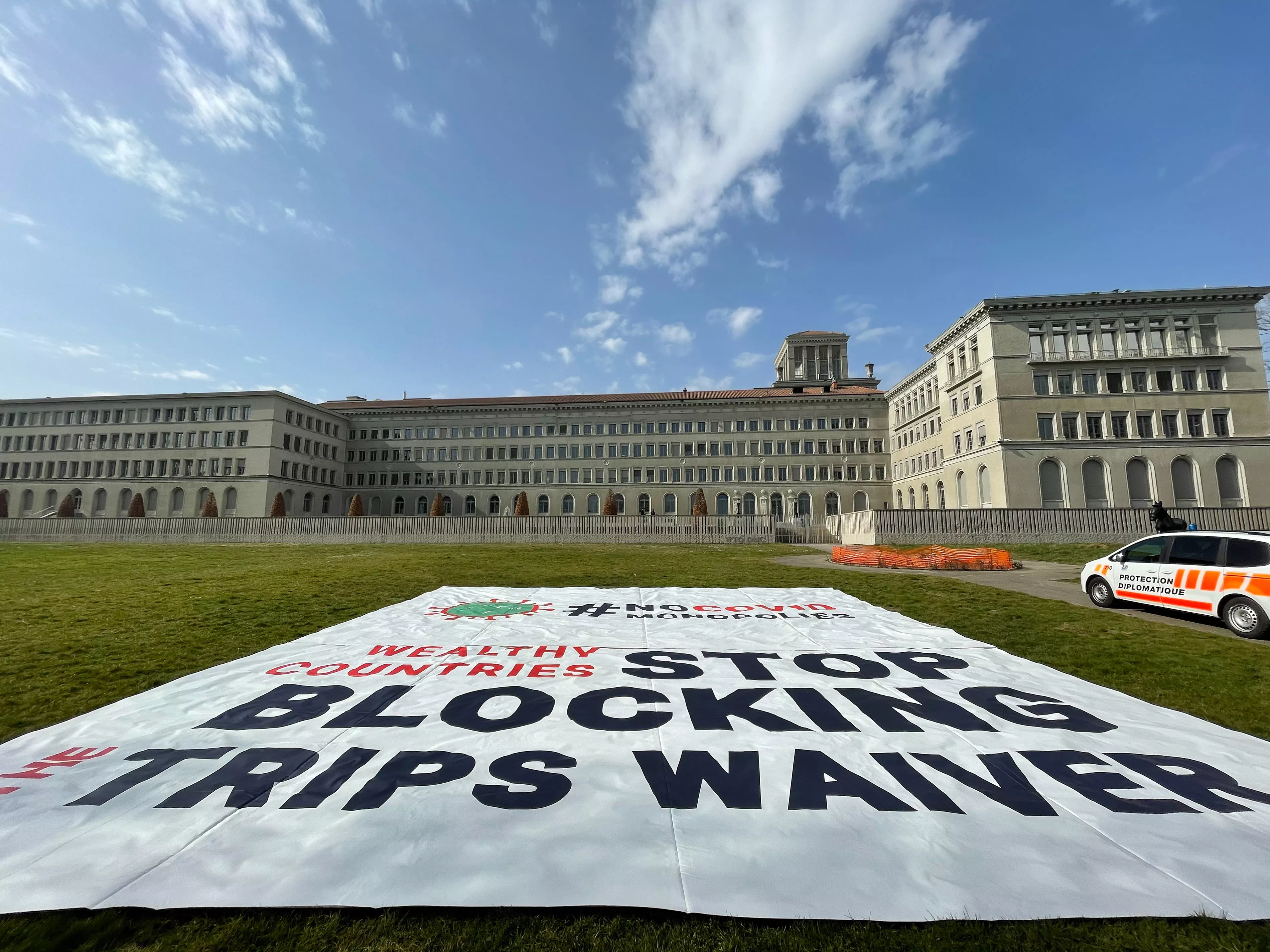 Banner deployed by MSF in front of the World Trade Organization (WTO) in Geneva calling on certain governments to stop blocking the landmark waiver proposal on intellectual property (IP) during the pandemic.
