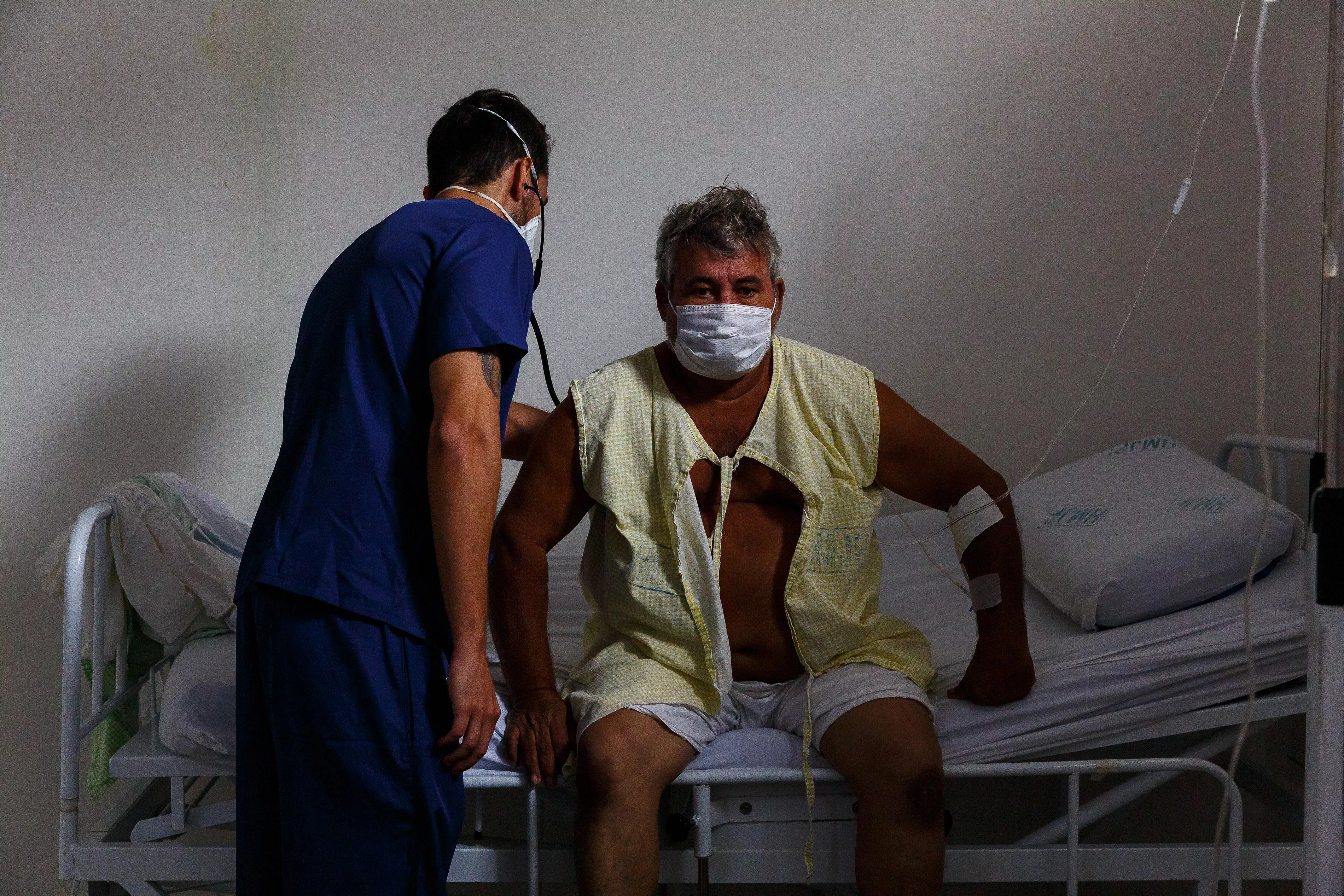 A medic attends to COVID-19 patient Antônio da Consolação Pinho in Ji-Paraná's Municipal Hospital, in Rondônia state, Brazil.