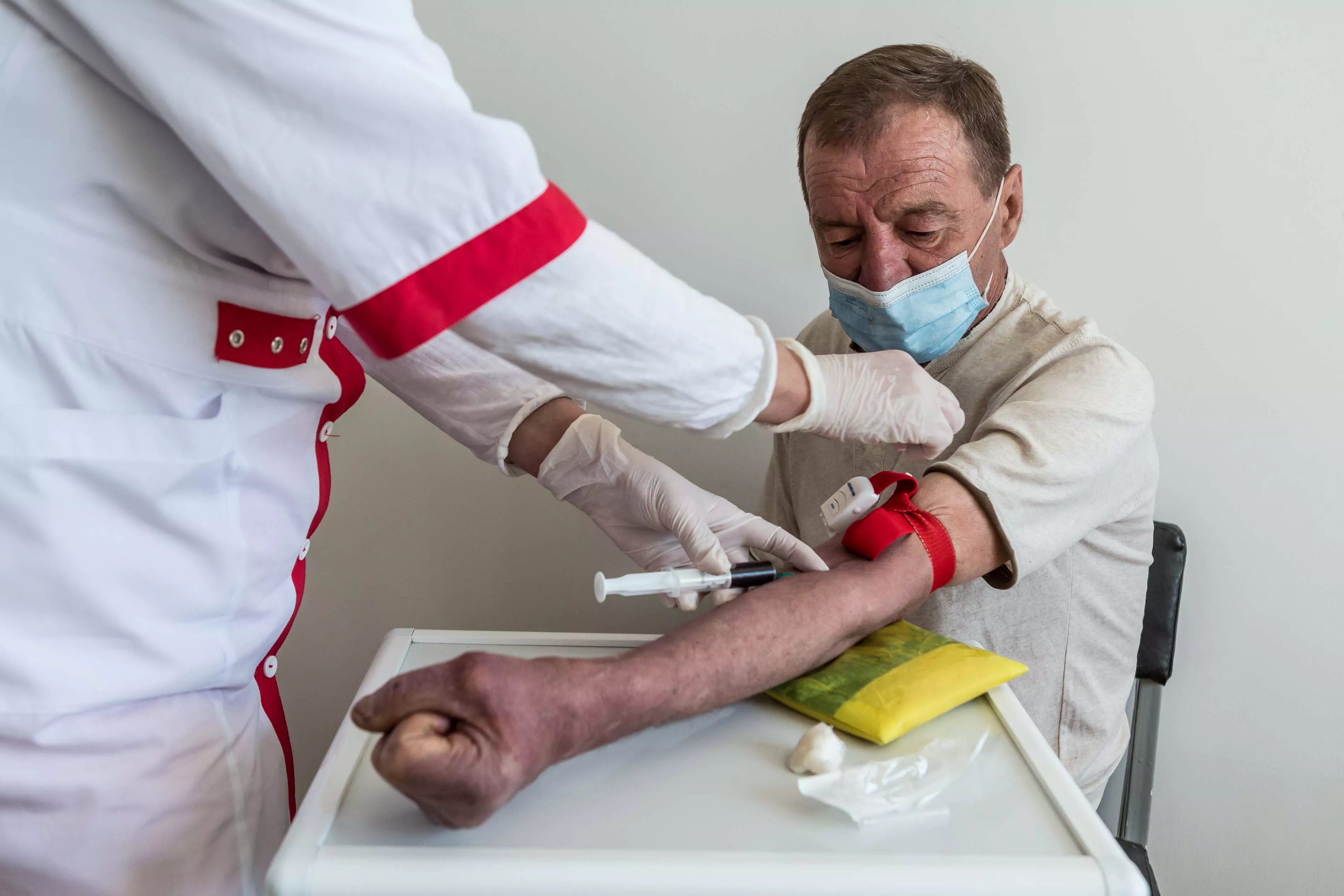 A nurse conducts a blood test on a DR-TB patient Dmitri Karpuk (name changed), 61 at the TB facility in Novograd-Volynsk district, Zhytomyr region, Ukraine.