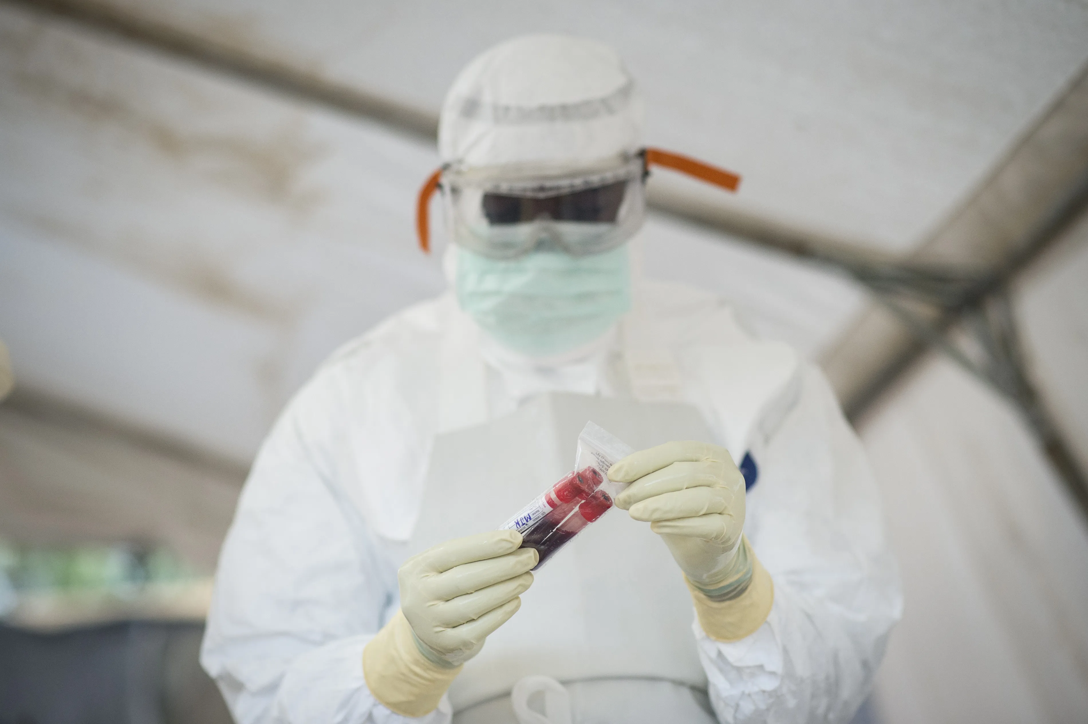 A lab assistant with blood samples from suspected EVD cases.