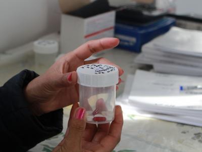 A DR-TB patient holding her daily dose at the Directly Observed Therapy corner, where patients pick up medicines for daily intake, in the Chimbay district of Karakalpakstan, Uzbekistan.