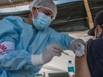 MSF nurse Maryuri Garcia Valladares administers a COVID-19 vaccine to a Venezuelan migrant at the MSF health post in Aguas Verdes, close to the Peru-Ecuador border.