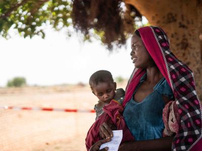 Zara Ahmat, 20, with her baby, Aba Abdulaziz, 1, just vaccinated against measles, Chad, 2019.