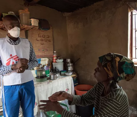 Celumusa Hlatswako, an MSF mobile counselor, visits Winile, 39, XDR-TB patient & HIV-positive. They use sign language to communicate because Winile went deaf due to the side effects of the treatment. Matsapha airport, Manzini Region, Swaziland.