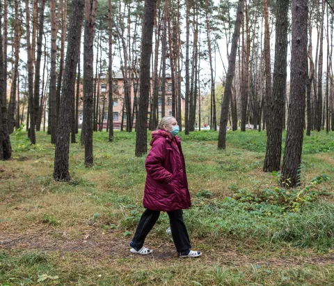 Halyna Uvarenko, 56, an MSF patient with multidrug-resistant TB (MDR-TB), walks in the forest around the Zhytomyr Regional TB Dispensary where she is receiving treatment. 