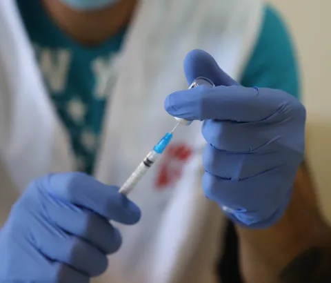 A member of MSF’s mobile vaccination team prepares a dose of COVID vaccine at a nursing home in Shayle, Lebanon, 2021