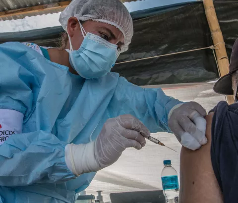 MSF nurse Maryuri Garcia Valladares administers a COVID-19 vaccine to a Venezuelan migrant at the MSF health post in Aguas Verdes, close to the Peru-Ecuador border.
