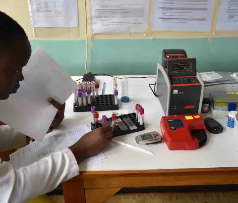 Clinician preparing samples for a point-of-care CD4 testing machine, Homa Bay County teaching and referral hospital, Kenya